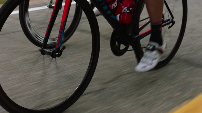 Feet are shown pedaling on bicycles