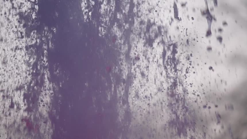 A turbulent splash of red wine erupts in a dynamic spray of droplets in super slow motion