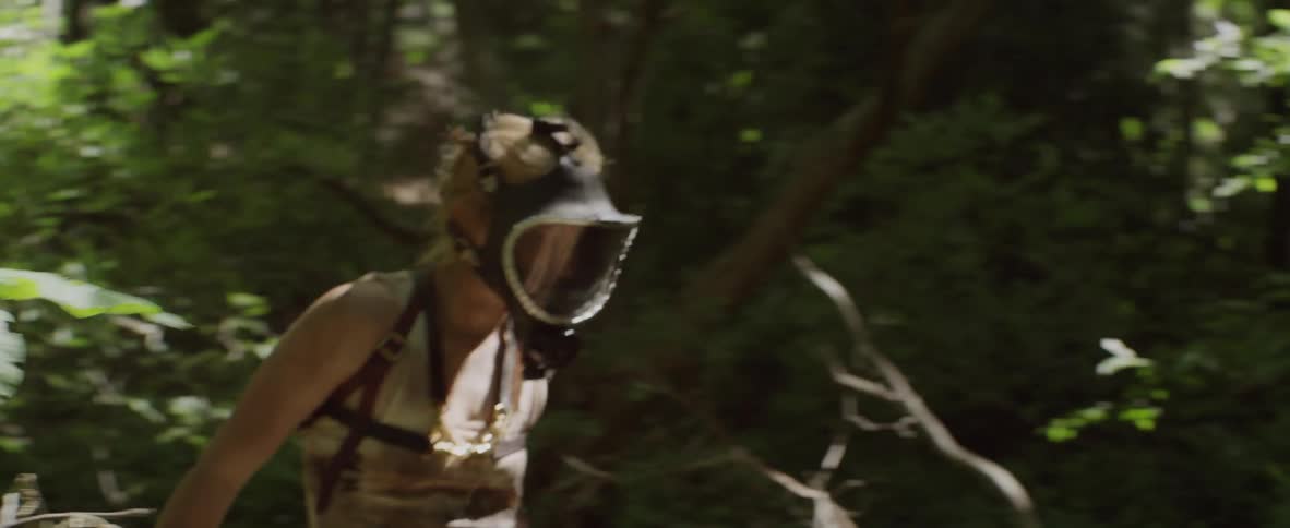 A woman in a mask moves through the forest