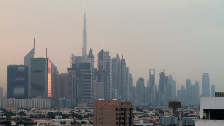 Tall buildings line the foggy city ahead
