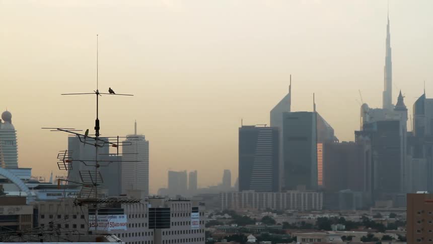 City buildings are shown at sunset