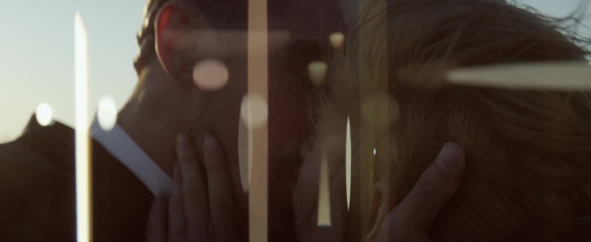 A man and woman kiss passionately