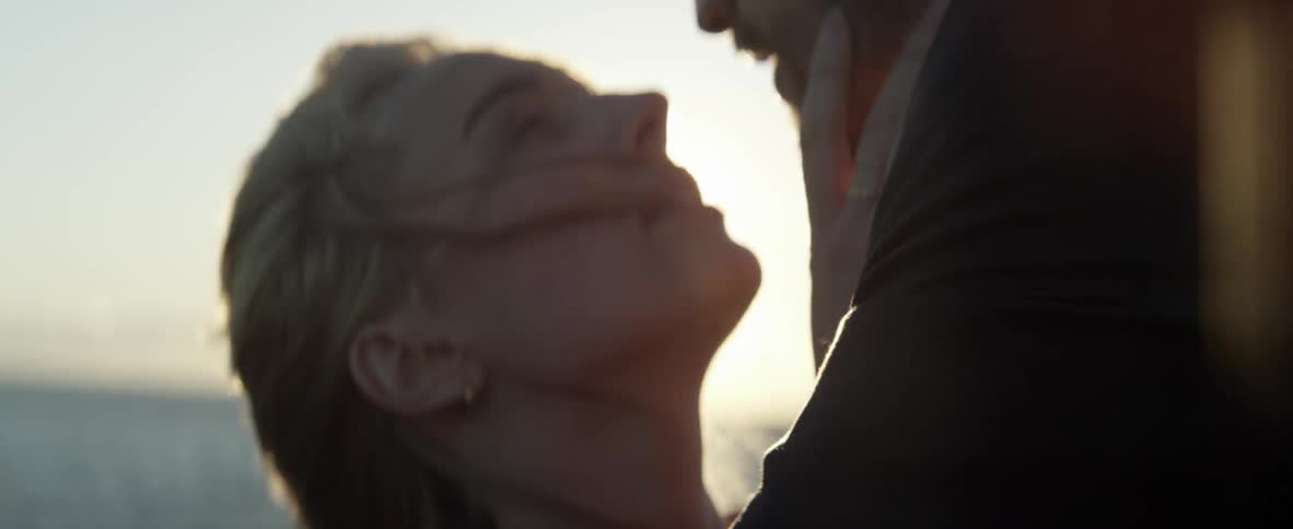 A woman and man stand face to face on a windy day