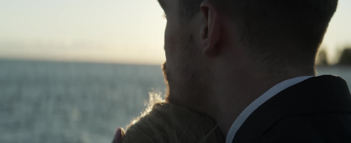 A man has a woman's head on his shoulder