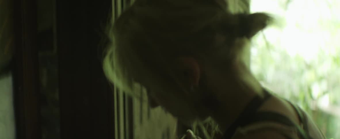 A woman carries string over to the front door