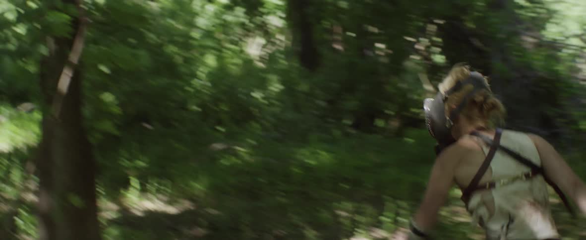 Woman running in the forest while wearing a mask