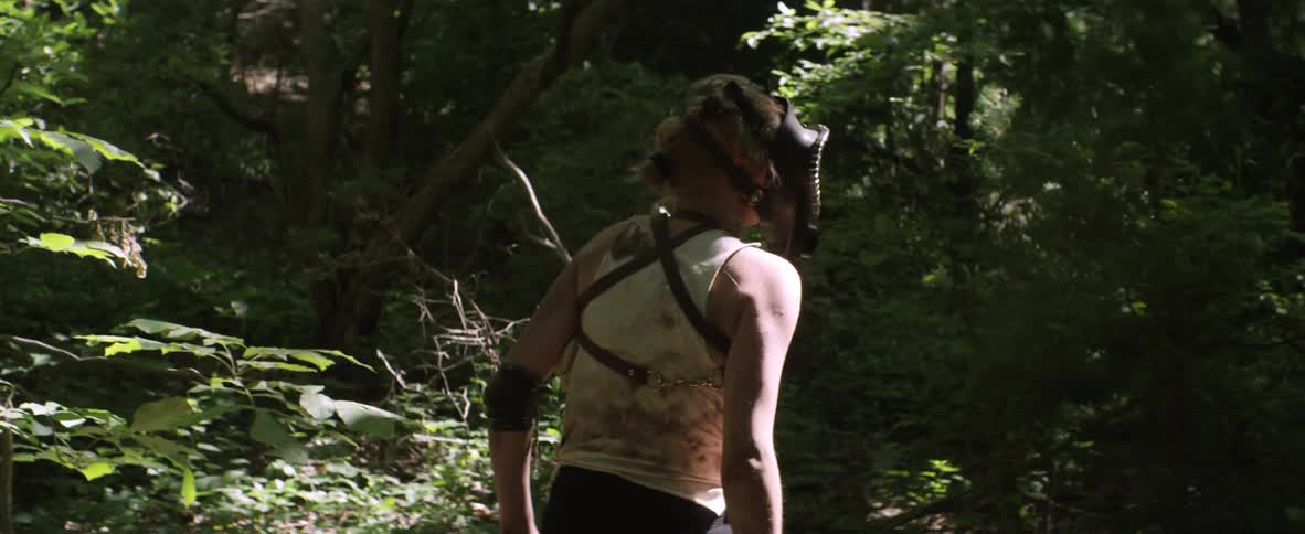 Woman wearing full face mask wandering through forest