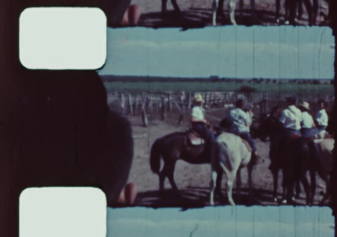 Archival footage shows a group of cowboys on horseback preparing to ride out from a ranch in the countryside