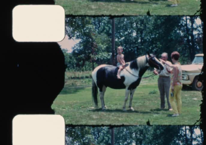 Vintage film captures a family visiting a tilted novelty house and a young boy's first horse ride in the countryside