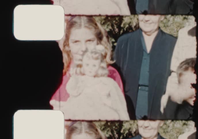 A vintage 8mm film strip reveals a happy family portrait centered on a young girl holding her doll