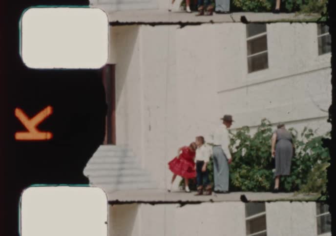 A collection of 1950s home movie clips featuring an Art Deco style building, a family on a sidewalk, and a quiet town street