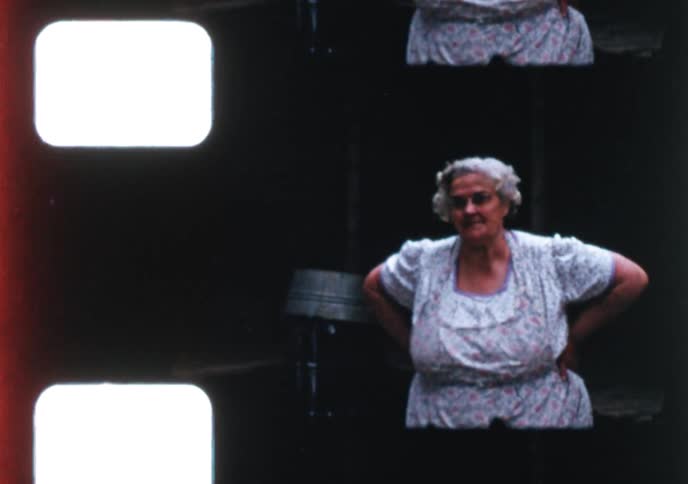 A sweet elderly couple poses together, and a man in a hat stands in a rural yard in vintage home movie clips from the 1950s