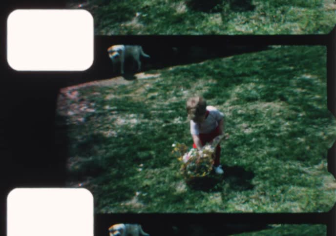 A nostalgic vintage home movie captures a toddler celebrating Easter in the backyard with a colorful basket and the family dog