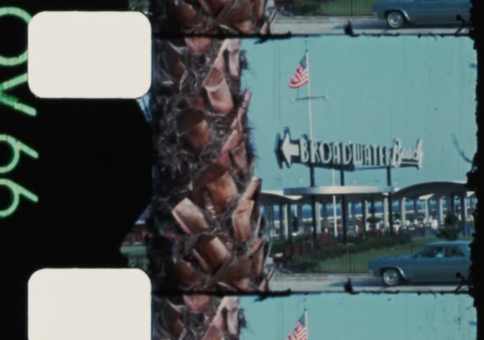 Vintage 8mm film from 1966 captures a U.S. Air Force jet, classic cars driving on a coastal highway, and the Broadwater Beach marina