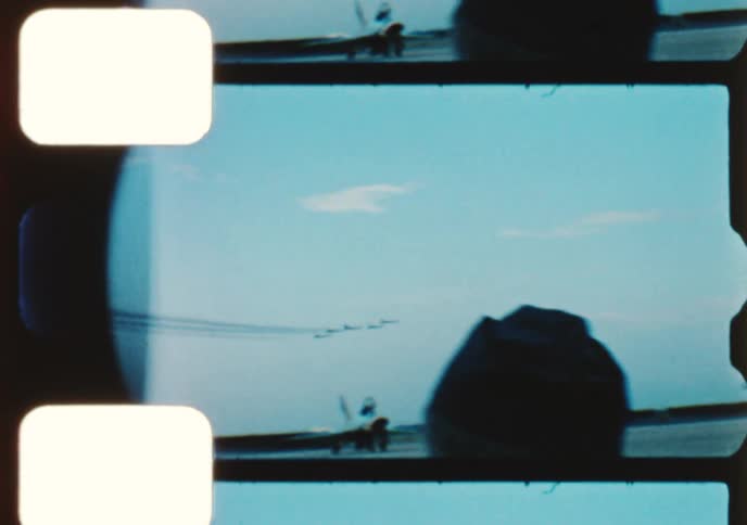Authentic 8mm film captures fighter jets performing impressive aerobatic maneuvers at a vintage airshow