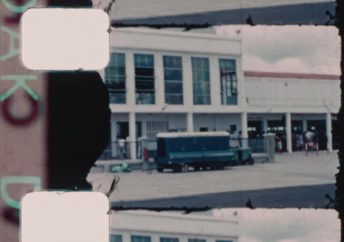 Vintage 1960s film captures a Braniff International Airways plane and the control tower at Asunción Airport in Paraguay