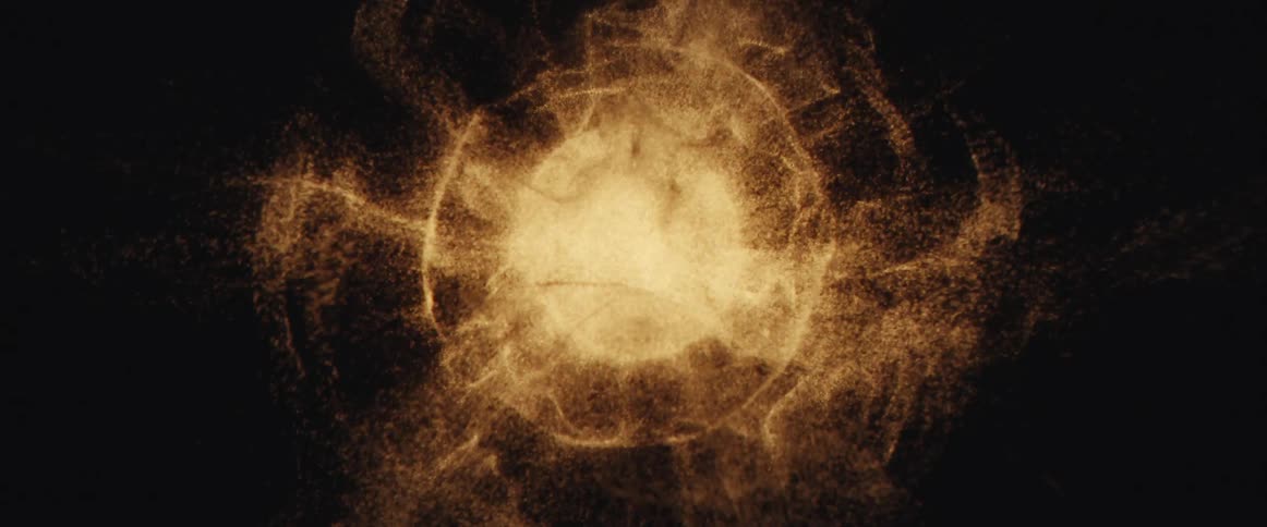 A glowing golden orb of shimmering particles expands and swirls into a celestial nebula against a dark void