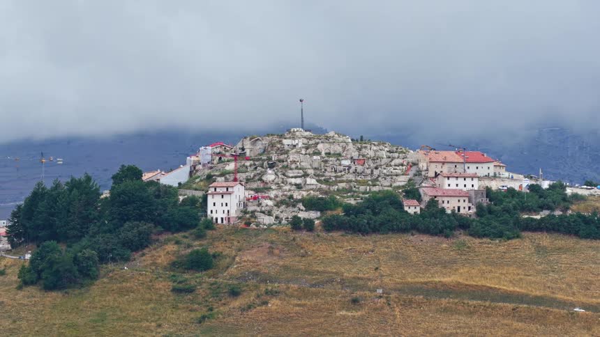Time-lapse of the historic Italian hilltop village of Calascio on a cloudy day, nestled in the Apennine Mountains