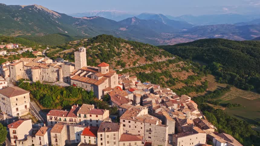 Breathtaking aerial view of the medieval village of Castel del Monte in the Abruzzo region of Italy, nestled in the green mountains