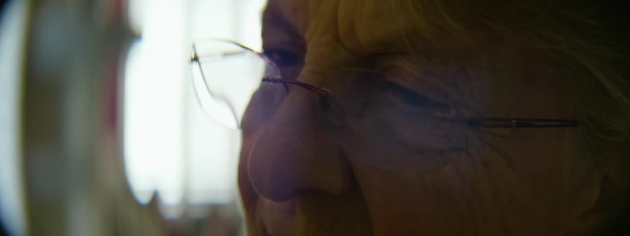 A person wearing glasses is talking