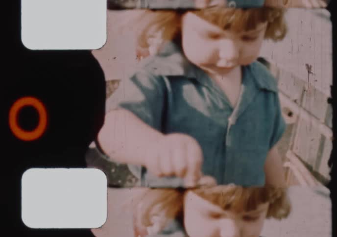 A curious toddler climbs on a stack of rental boats and then shows off a starfish in this charming vintage 8mm home movie