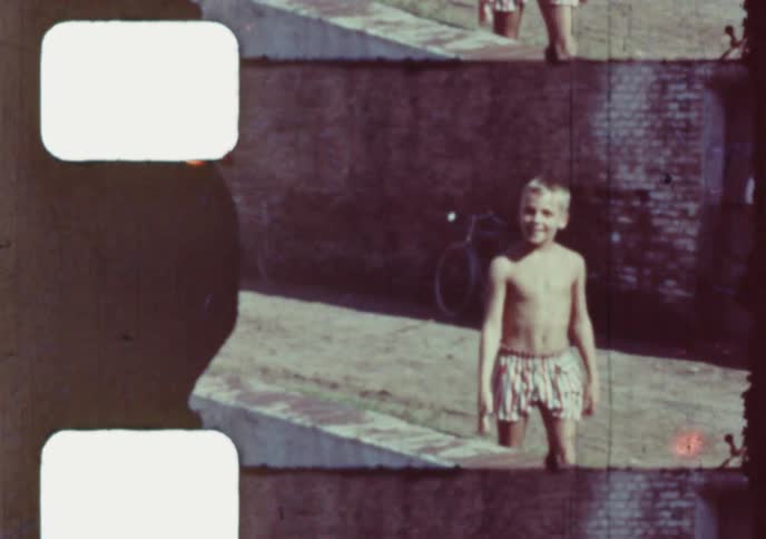 Vintage 8mm film strip effect shows scenes of children playing with toy boats and adults relaxing on a sunny summer day