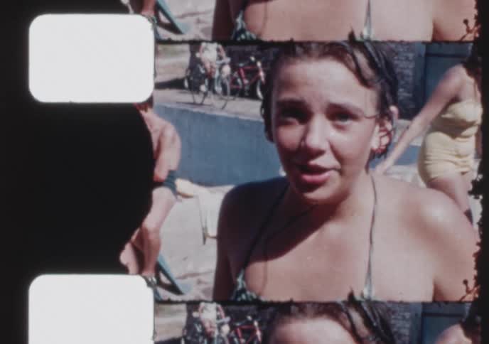 A collection of vintage 8mm film clips showing kids and teens diving, swimming, and enjoying a summer day at the local pool