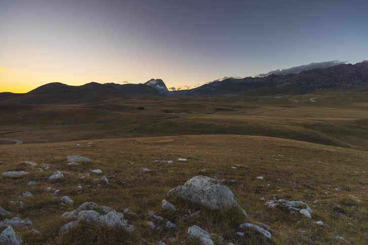 Breathtaking timelapse of a golden sunset fading into twilight over a vast mountain valley