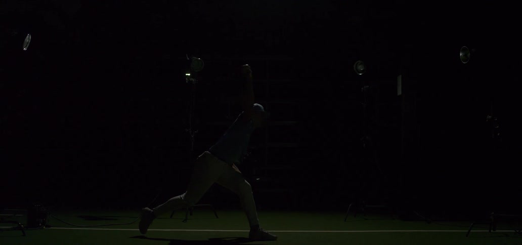 A baseball pitcher throws a fastball in dramatic super slow motion with strobe lights flashing to capture the powerful motion