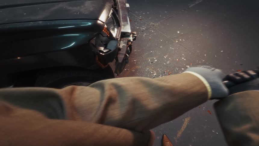 Slow motion, first-person view of a person furiously smashing a damaged car's headlight with a baseball bat in a garage