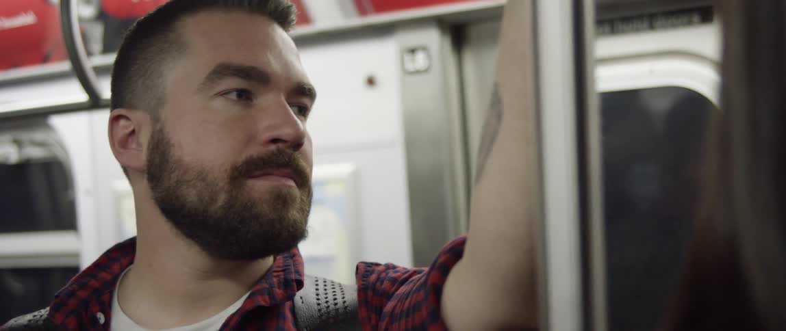 A man rides a subway train