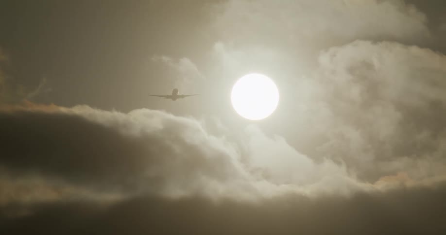 An airplane takes off into a hazy sky while another comes in for a landing, silhouetted against the bright sun