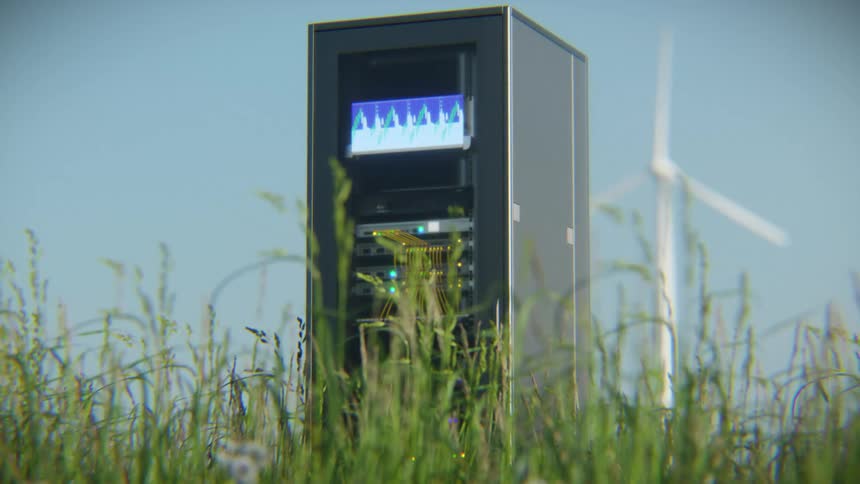 An animated server rack stands in a lush green field with a wind turbine in the background, representing green energy and sustainable technology