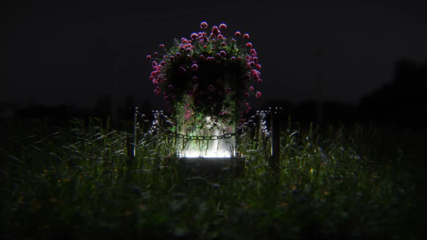 An ethereal shot of a flower planter glowing in the middle of a dark grassy field at night