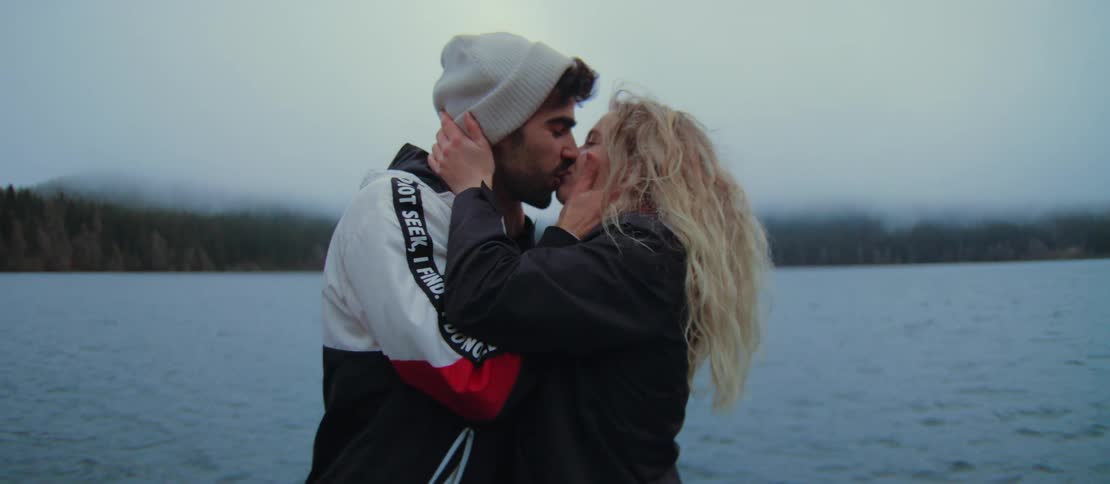 A young man surprises his girlfriend with a romantic marriage proposal by a foggy lake, and she happily accepts