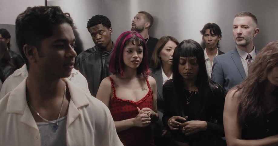A diverse group of people in a crowded elevator are filled with anxiety and fear as it malfunctions and the lights flicker