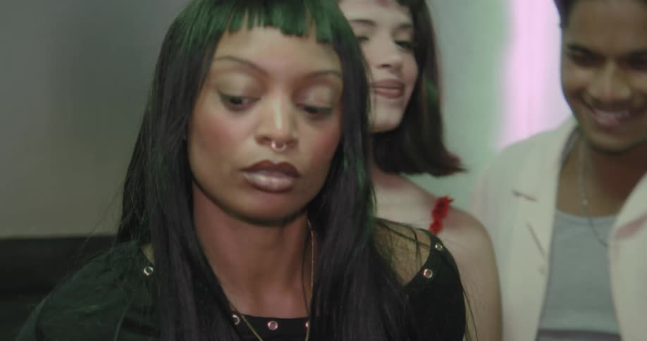 A group of stylish friends take selfies and dance together while riding in an elevator