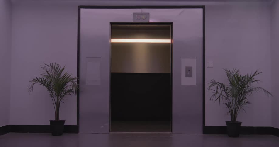 A modern stainless steel elevator's doors open and close in a seamless loop within a purple-lit hallway