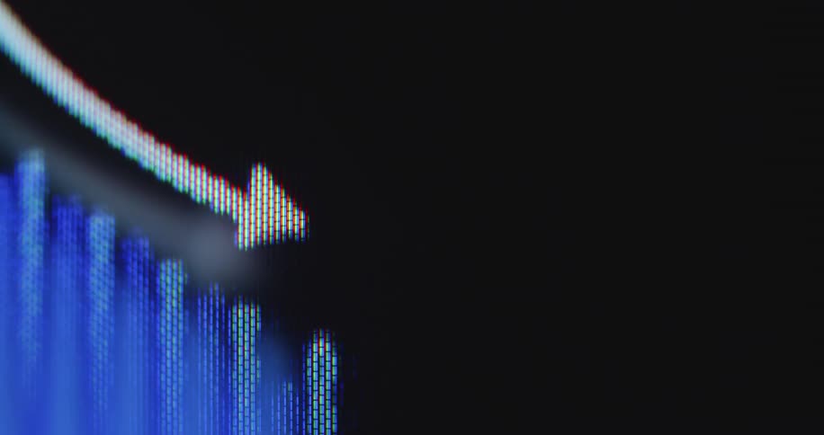 Extreme close-up macro shot of a blue financial bar graph on a computer screen with a white arrow indicating a downward trend