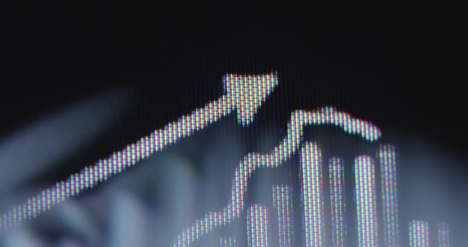 Macro view of a digital screen showing a white animated financial graph and arrow moving upwards on a black background