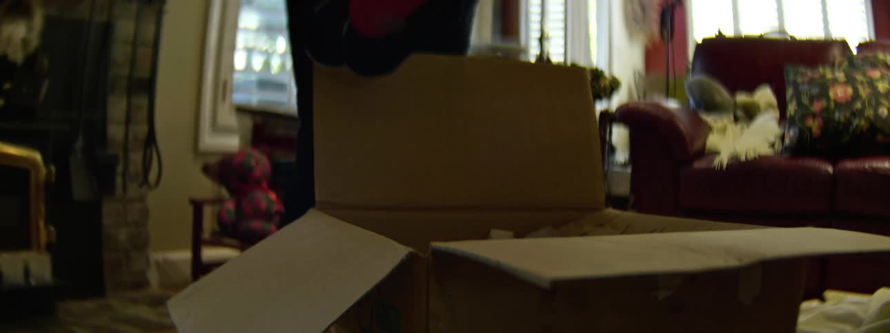 A woman grabbing stockings out of a box