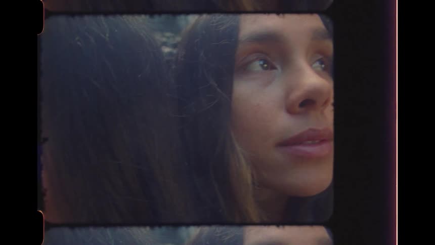 A close-up vintage 16mm film strip reveals the thoughtful portraits of two beautiful women in a serene, natural setting