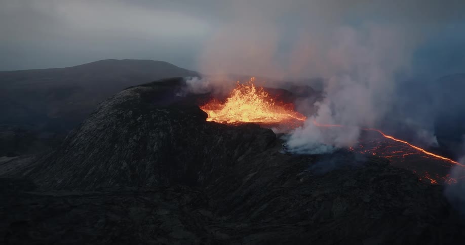 A powerful volcanic eruption with bubbling molten lava spewing from a crater amid thick smoke under a gloomy, overcast sky