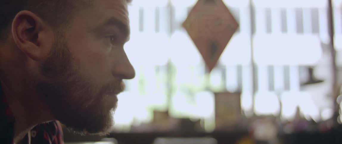 Bearded man looks around inside a building