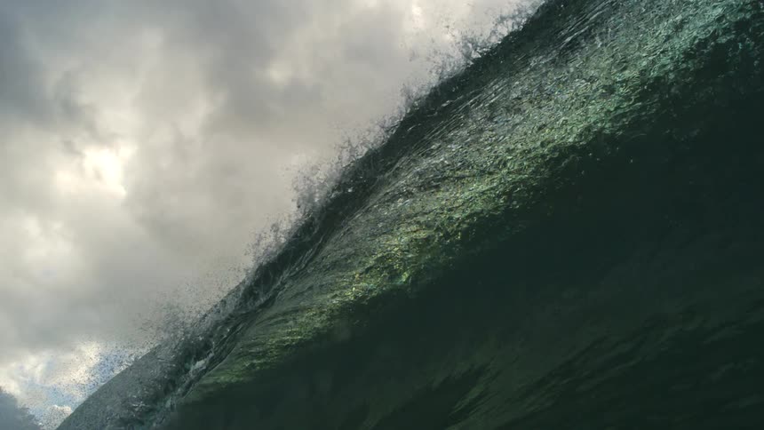 A mesmerizing slow-motion underwater view from inside the barrel of a powerful ocean wave