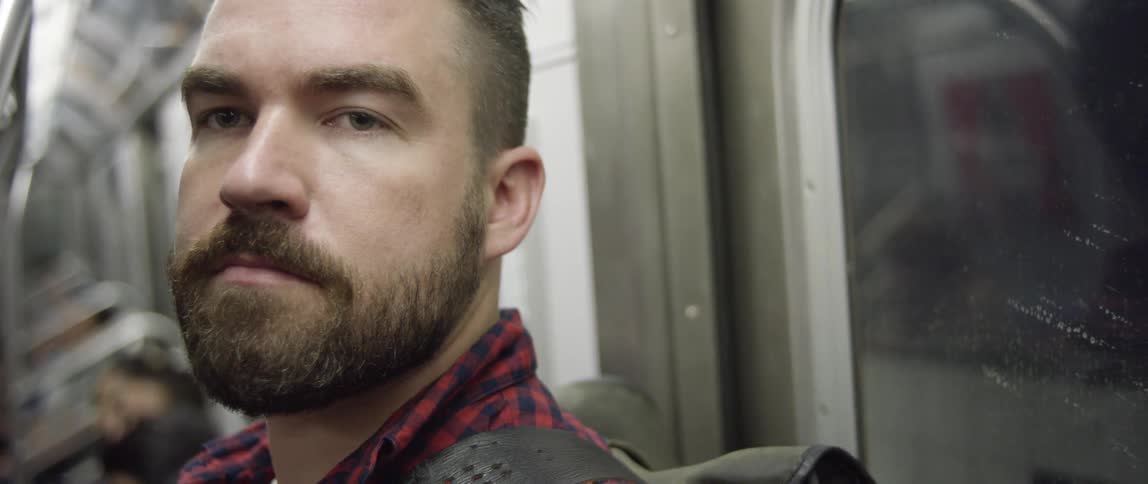 A man rides the subway lost in thought