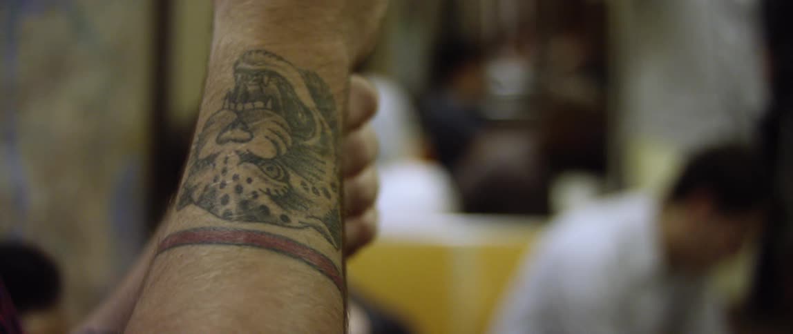 A cheetah is tattooed on a person's arm
