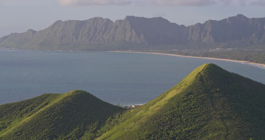 A scenic shot of the Koolau Mountain Range and Waimanalo Bay in Oahu, Hawaii, viewed from the iconic Lanikai Pillbox Trail