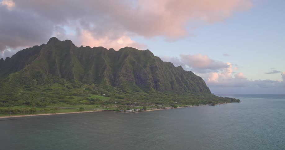 Sweeping aerial footage captures the stunning Koʻolau mountain range along the coast of Oahu, Hawaii at sunrise