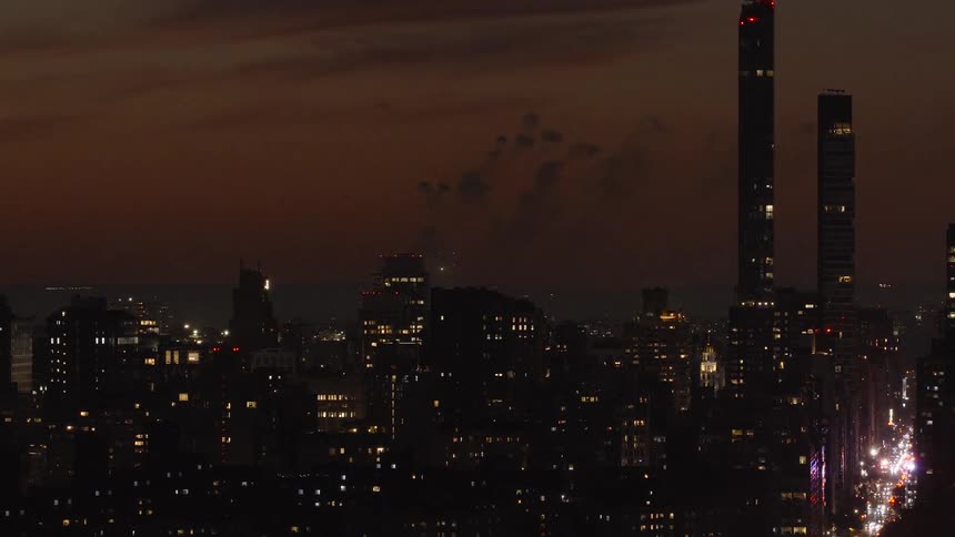 A colorful fireworks display erupts over the New York City skyline as seen from a high-angle view at night